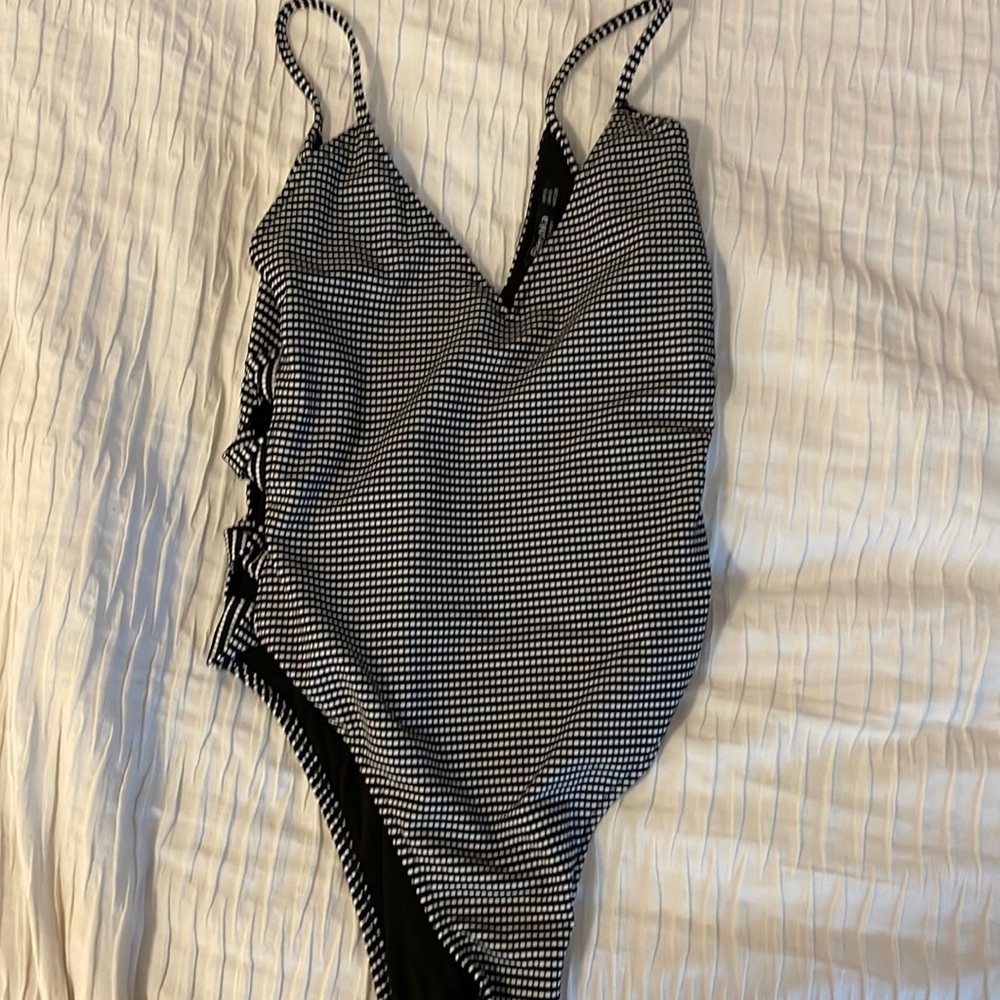 Black and white body suit with cut outs on side